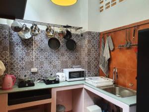a small kitchen with a sink and a microwave at Great House for Families and Big Groups in Bangkok