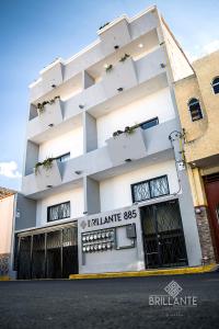 un edificio blanco con un cartel delante en Condominio Brillante GDL en Guadalajara