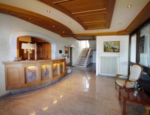 a living room with a wooden ceiling and a staircase at Vintage Hotel Petrisberg in Trier