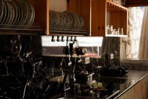 a kitchen with a sink and a counter with dishes at Foti Rooms in Himare