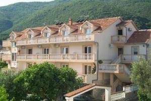 a large building with balconies on the side of it at B&B Guest House Vasiljevic in Herceg-Novi