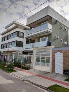 a large apartment building with a garage at DEUS é bom o tempo todo in Governador Celso Ramos