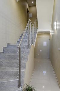 a staircase in a building with stainless steel railings at Média Panzió és Apartmanház in Hajdúszoboszló