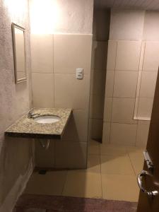 a bathroom with a sink in a stall at Hotel Casa Branca in Garanhuns
