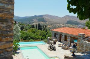 a villa with a swimming pool and a house at The House of Prince in Nea Stira