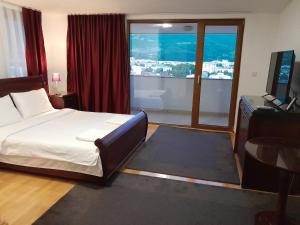 a bedroom with a bed and a large window at Villa Bella in Ohrid
