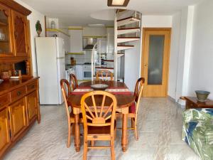 a kitchen and dining room with a table and chairs at Chez Marina in Les Cases d'Alcanar +25 photos