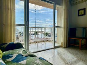 a bedroom with a large glass door to a balcony at Chez Marina in Les Cases d'Alcanar