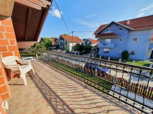 a balcony with a chair and a view of a river at House Antea in Lučko