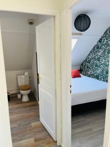 een kleine slaapkamer met een bed en een toilet bij Appartement Cosy en coeur de vieille ville in Boulogne-sur-Mer