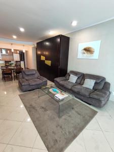 a living room with two couches and a coffee table at Sole Mio Apartment & Wellness in Herceg-Novi