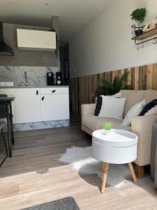 a living room with a couch and a table at Casa Bianco in Koudekerke +6 photos