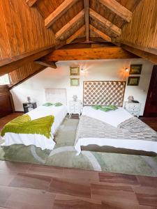 two beds in a room with wooden ceilings at Casa Grande do Seixo in Vidago +50 photos