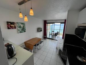 a kitchen and dining room with a view of the ocean at Cannes - view Cap Esterel in Cannes