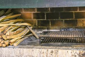a pile of wood next to a bench next to a brick wall at Apartmani Kraljevica in Kraljevica