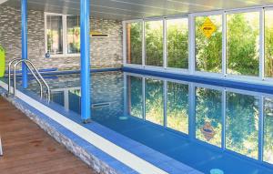 a swimming pool with blue floors and windows at Apartmani Kraljevica in Kraljevica