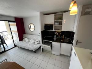 a small kitchen with a couch and a table at Cannes - view Cap Esterel in Cannes