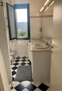 a bathroom with a sink and a toilet and a window at Antica Casa Prile in Castiglione della Pescaia