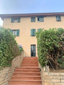a house with a staircase leading up to a door at Antica Casa Prile in Castiglione della Pescaia