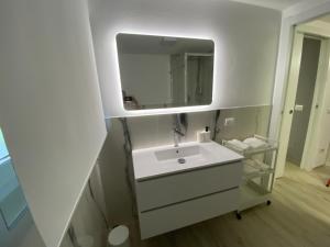 a bathroom with a white sink and a mirror at Lido Appartamento Parcheggio Privato 400 mt dal mare in Lido di Camaiore +45 photos