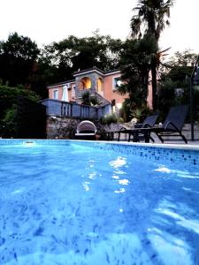 a large swimming pool in front of a house at Villa Lella in Rukavac