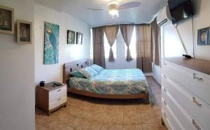 a bedroom with a bed and a window at Playa Azul II 302 in Luquillo