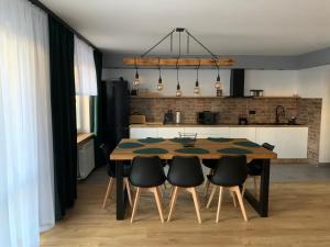 a dining room table and chairs in a kitchen at Domek na Malniku in Muszyna