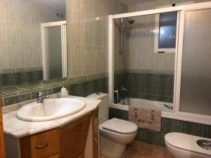 a bathroom with a sink and a toilet at Playa Vinaroz in Vinarós