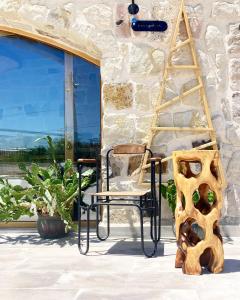 a chair sitting on a porch next to a window at Naif Hotel - Adults Only in Göreme