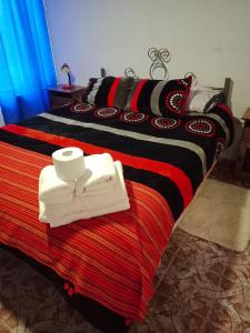 a bedroom with two beds with towels on it at Katchi in San Pedro de Atacama