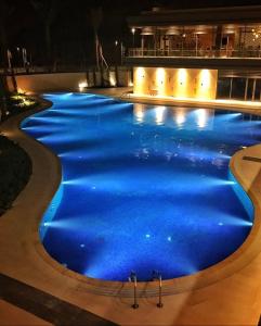 a swimming pool lit up at night at Al Raha Village - Aqaba in Aqaba