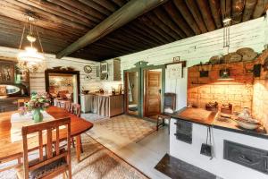 a kitchen and dining room with a table and chairs at Matsi cottage in Igaküla