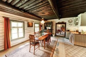 a kitchen and dining room with a table and chairs at Matsi cottage in Igaküla