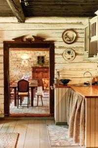 a kitchen with a door leading to a dining room at Matsi cottage in Igaküla