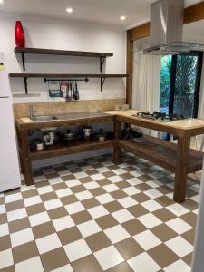 a kitchen with a checkered floor at Tamborine Accommodation 84 Eagle Heights Road 6 Bedroom 3 Baths Parking Complete Holiday Home in Mount Tamborine