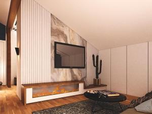 ein Wohnzimmer mit einem TV an der Wand in der Unterkunft Boutique Hotel OchSen in Bad Ragaz