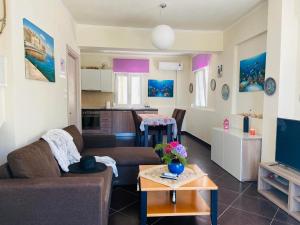 a living room with a couch and a table at Villa Vision in Skala Potamias