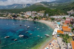 an aerial view of a beach with boats in the water at Blanche Cliff Apartments in Sveti Stefan