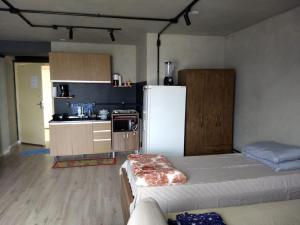 a kitchen with a white refrigerator in a room at Espaço aconchegante - Centro - São Paulo in Sao Paulo