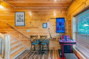 a room with two bar stools in a log cabin at Mountain Creek Lodge in Pigeon Forge