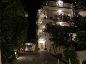 a white van parked in front of a building at night at Guest house Adria in Dugi Rat