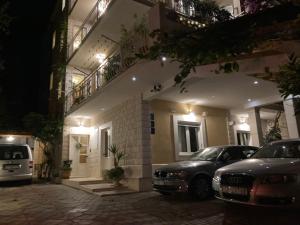 two cars parked in front of a building at night at Guest house Adria in Dugi Rat