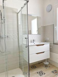 a bathroom with a glass shower and a sink at Cocciu D'Amuri in Olbia