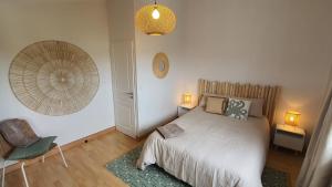 a bedroom with a bed and a clock on the wall at Villa Bahia - ADRIAE Home in LʼAiguillon-sur-Mer +18 photos
