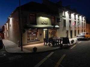 a table and chairs outside of a building at night at The Acres B&B in Killala