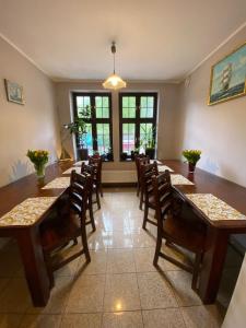 a dining room with a long table and chairs at Hostel Przy Targu Rybnym in Gdańsk +49 photos