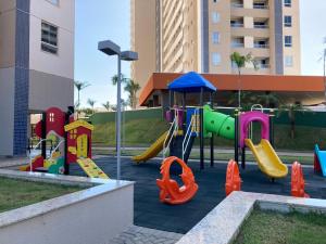 a playground with a slide in a park at Apartamento Solar das Águas Park Resort in Olímpia
