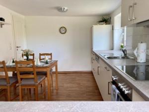 a kitchen with a dining table and a white refrigerator at Ferienhaus-Spatzenvilla in Lübeck