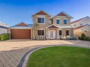 a large house with a driveway at "WATERLILY HOUSE" - Luxury Canal House, Jetty, Dog & Child Friendly - Sleeps 14 in Mandurah