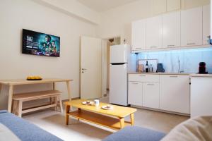a kitchen with a white refrigerator and a table at Casa olive in Tolo